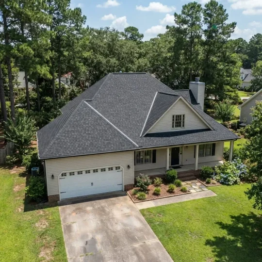 Completed asphalt shingle roof on a two-storey home in Manteo, North Carolina